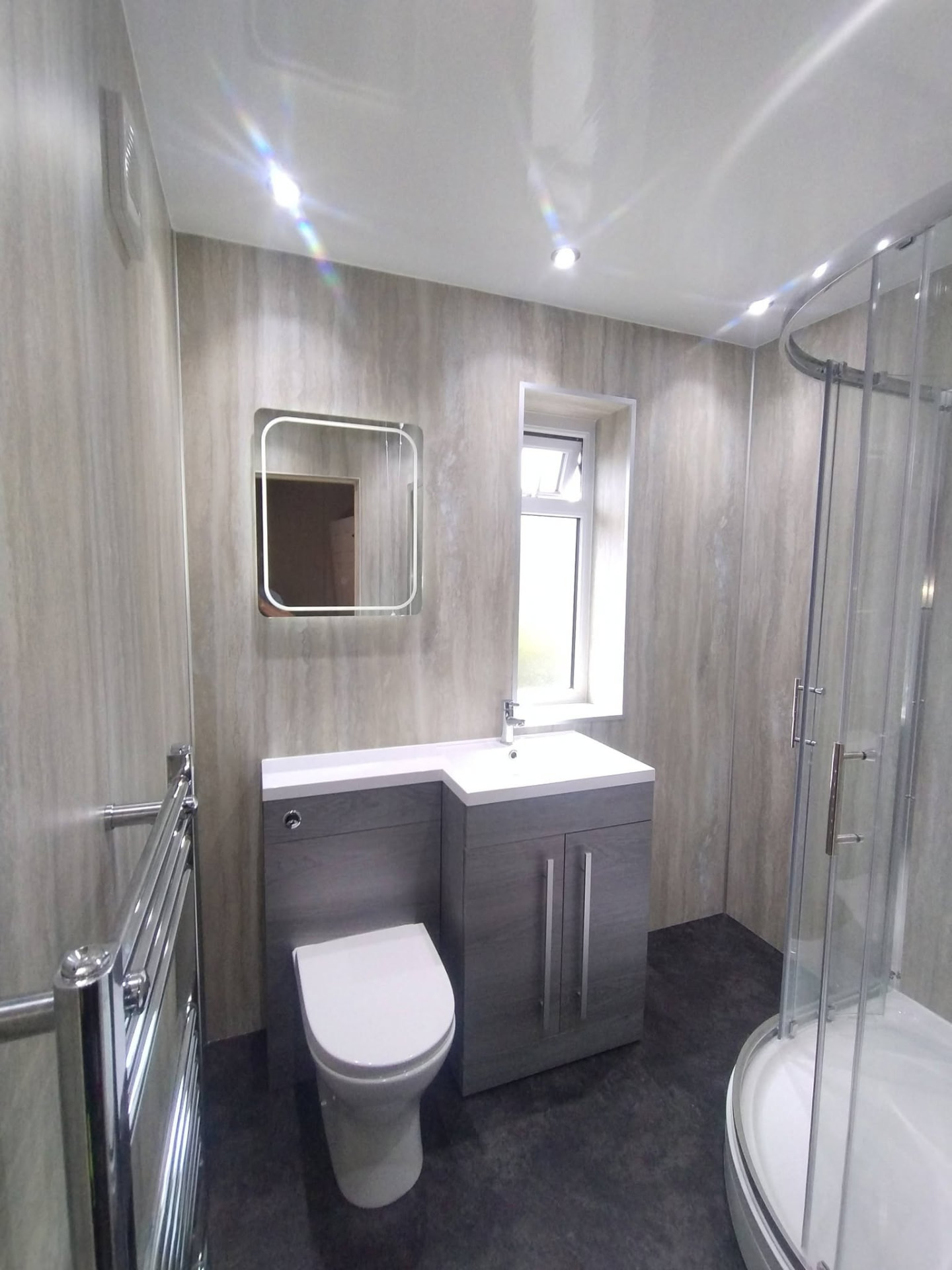 Compact grey bathroom fitted by Re-Design Services