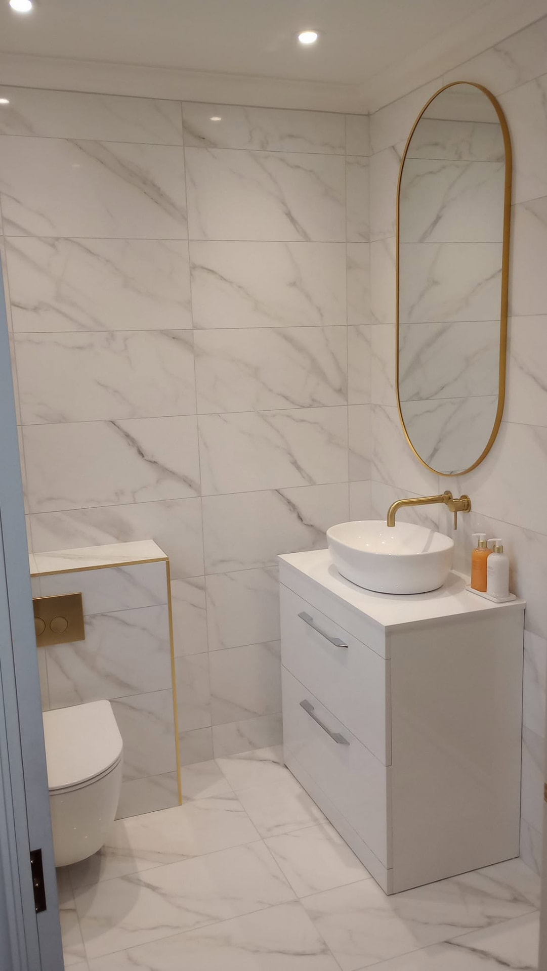 White marble bathroom with gold fittings